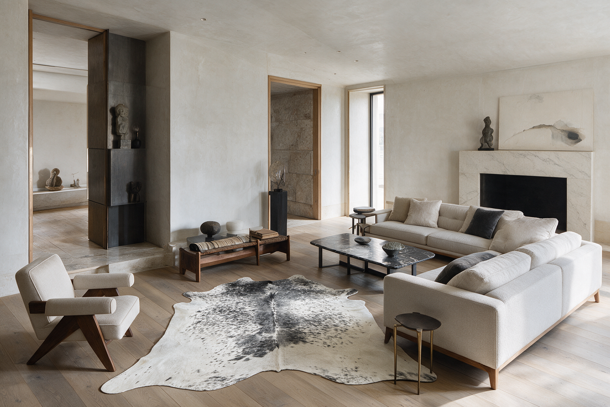 Gray and white cowhide rug in a sophisticated contemporary living room with warm oak floors