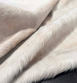 Close-up of light-colored cowhide fur texture