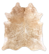 Beige cowhide rug on a white background