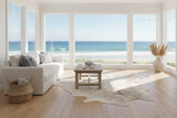 gray cowhide rug in beach home - staged
