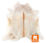 brown white cowhide rug on a white background