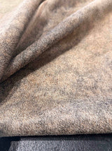 Close-up of cowhide rug on a wooden surface
