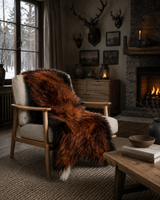 Luxury long wool sheepskin rug draped over chair in Scandinavian interior