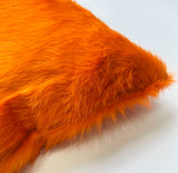 Valencia orange cowhide pillow detail showing hidden zipper closure