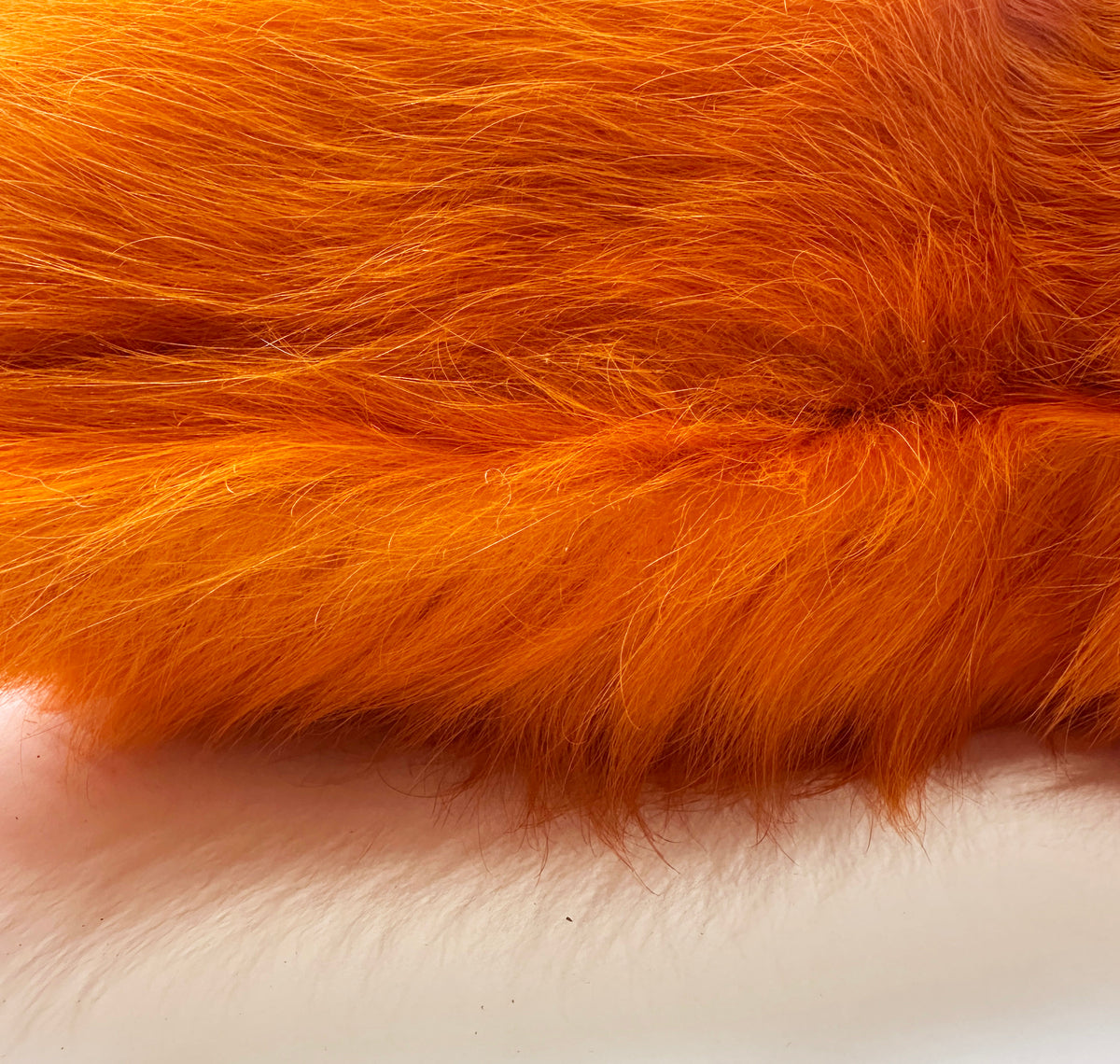 Close-up of Valencia orange cowhide showing natural hair-on-hide texture