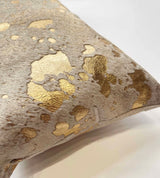 Close-up of metallic gold cowhide pillow showing natural hair and gold finish