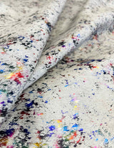 Close-up of cowhide with multicolored speckles on a white background