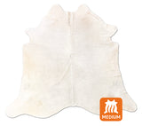 White cowhide rug on a white background