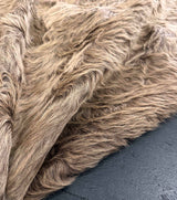 Close-up of brown cowhide rug on a dark surface