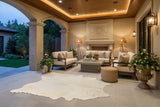staged white cowhide rug on patio