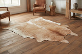 Brown cowhide rug staged in rustic farmhouse