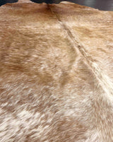 brown white cowhide rug