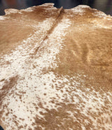 Brown and white cowhide rug with natural patterns