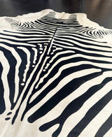 Zebra-patterned rug on a dark surface