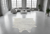 Modern living room with a white cowhide rug on a concrete floor
