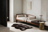 Natural dark brown UK sheepskin rug styled in a luxury contemporary interior