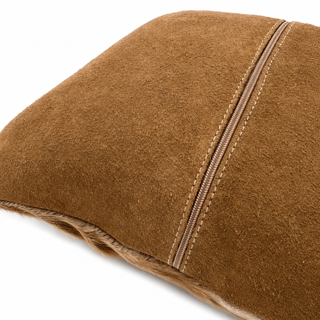 Cognac-tan genuine suede backing of African springbok pillow, showing natural suede texture, zipper closure, and detailed stitching.