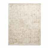 Enchanté custom stitched cowhide rug in ivory and cream with a repeating interlocking I-and-H geometric pattern