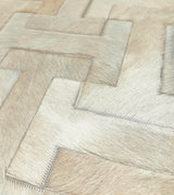 Close-up of Enchanté tonal ivory cowhide pieces with natural hair texture and coordinating zigzag stitching