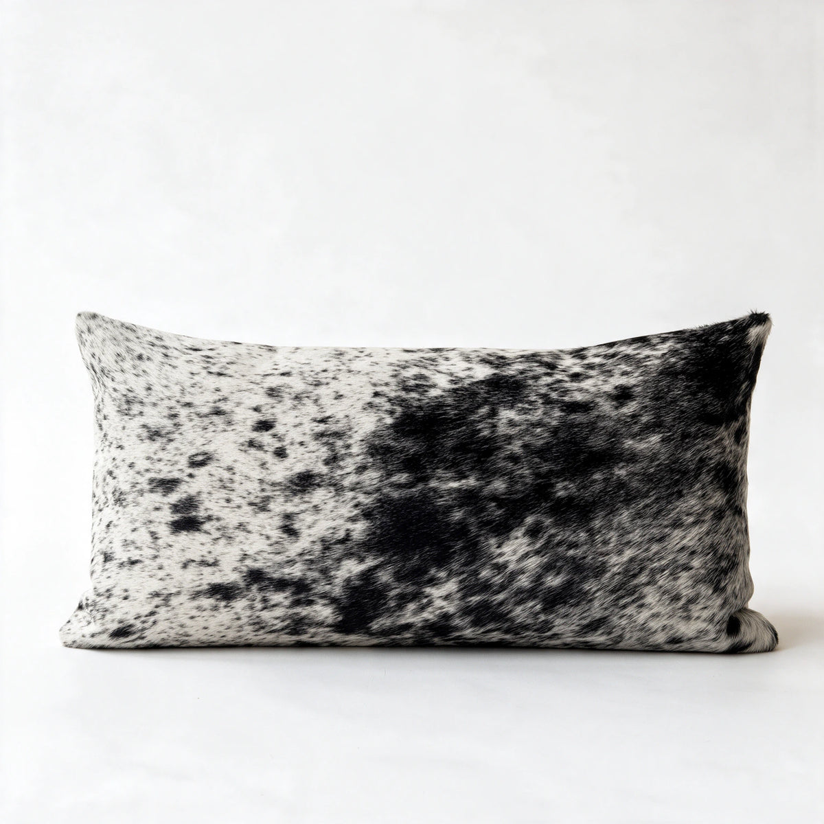 Natural salt and pepper black and white cowhide lumbar pillow in 12 x 24 size