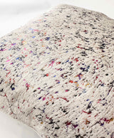 Close-up of iridescent cowhide pillow showing multicolor finish and hair-on-hide texture
