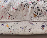 Iridescent cowhide pillow detail showing hidden zipper and genuine hair-on-hide