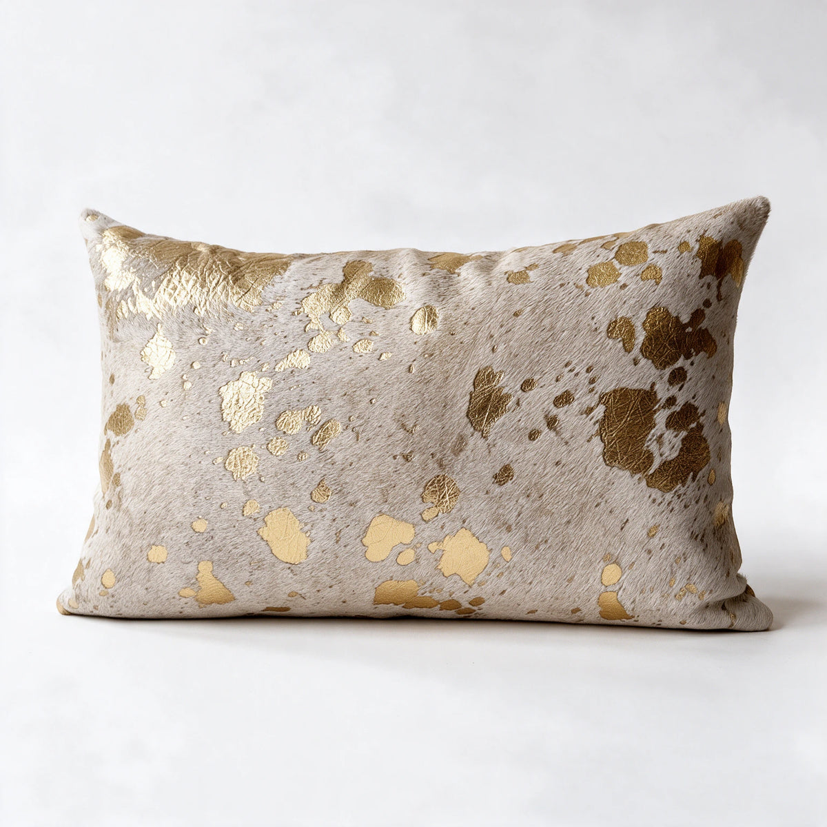 Metallic gold and natural white cowhide pillow in 12 x 20 lumbar size