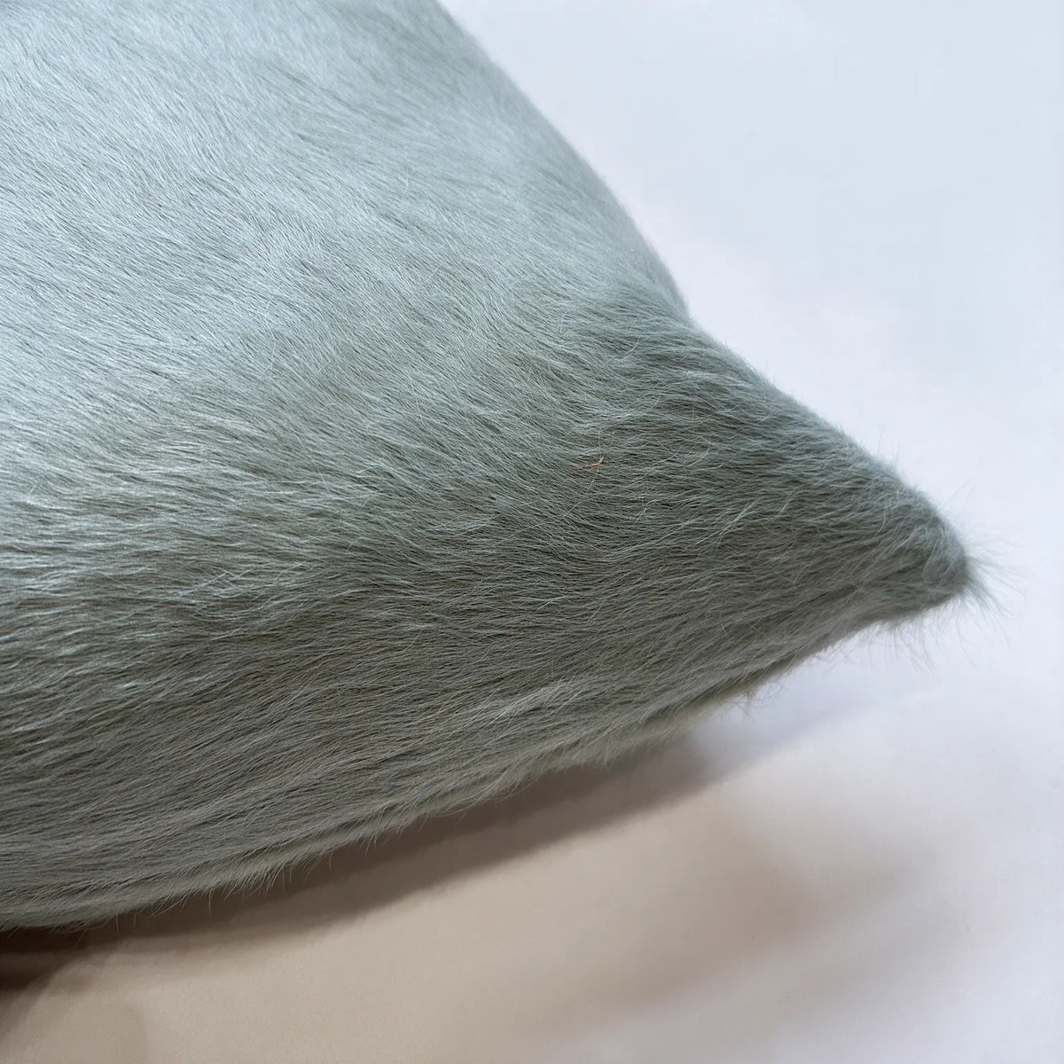 Close-up of Sea Glass blue cowhide pillow showing natural hair-on-hide texture