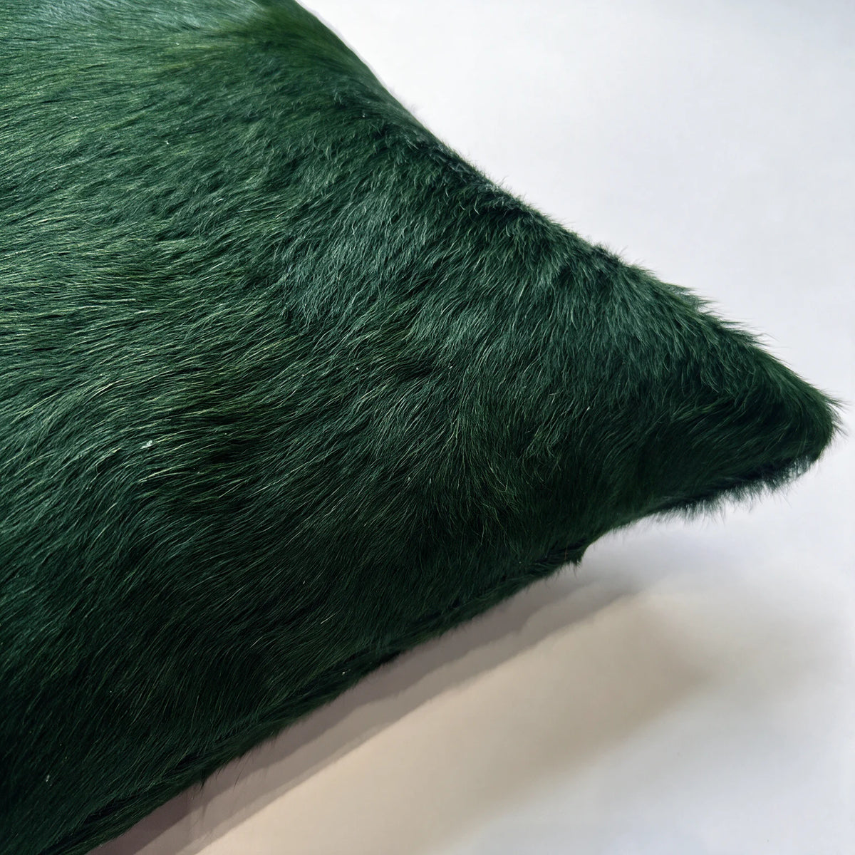 Close-up of Shamrock green cowhide pillow showing natural hair texture