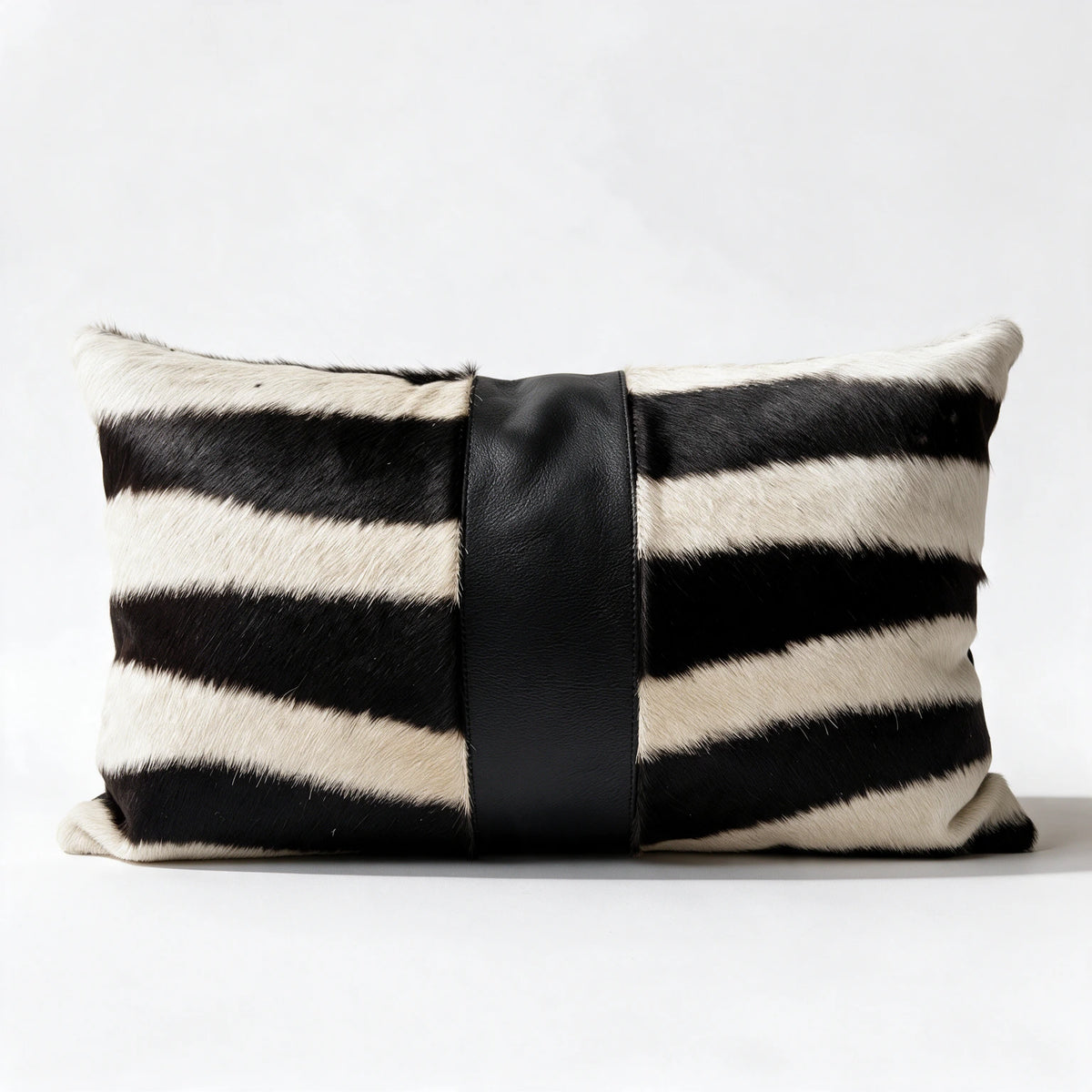 Authentic zebra hide pillow with black leather center accent
