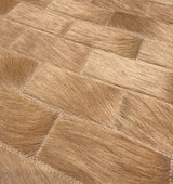 Close-up of Savona’s tonal camel hair-on cowhide rectangles, showing natural hair direction and zigzag stitching.