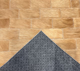 Savona stitched cowhide sample with a corner turned back to reveal gray felt backing and small black rubber grip dots.