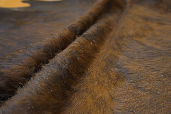 brown black cowhide fur rug