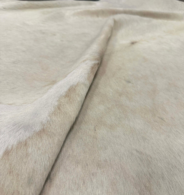 beige cowhide rug