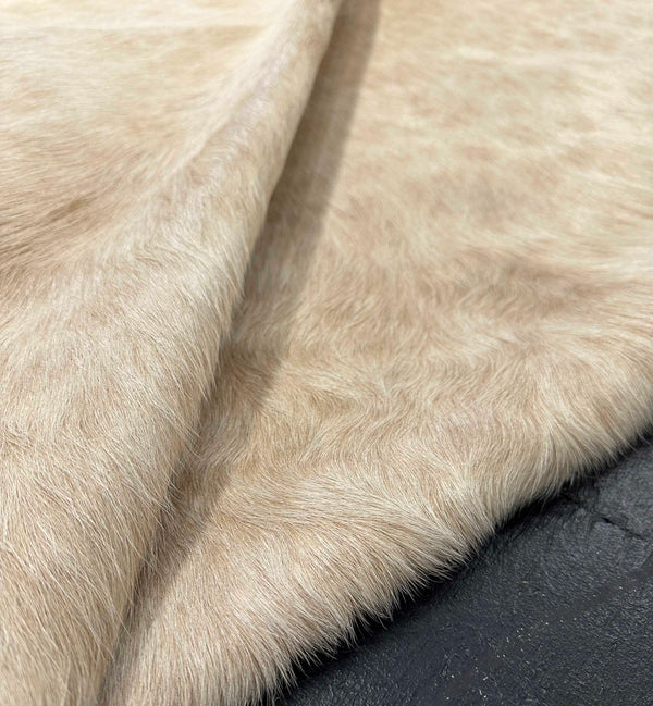 shaggy beige cowhide rug