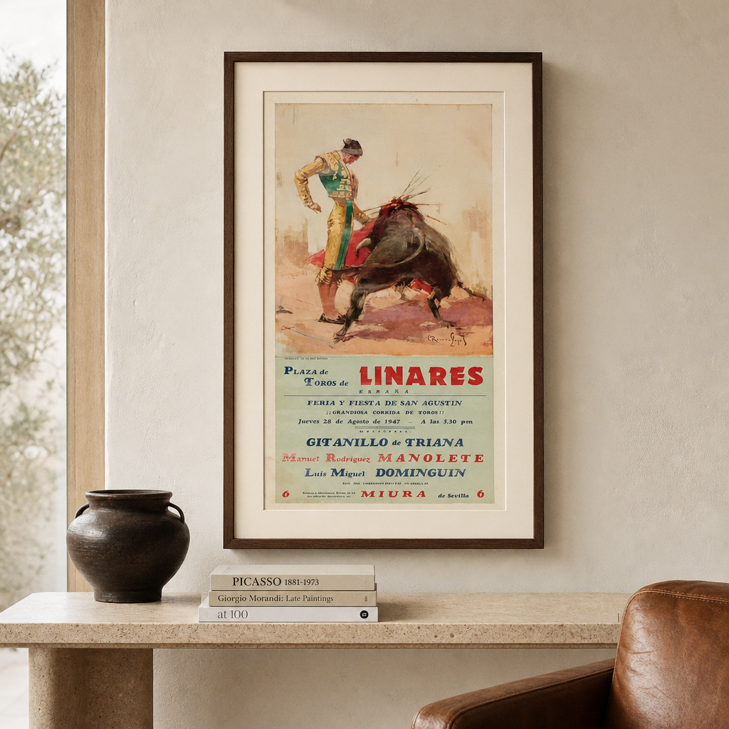 Vintage Linares poster displayed in a walnut frame above a travertine console beside a leather chair; framing for illustration only.