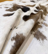 brown white cowhide rug