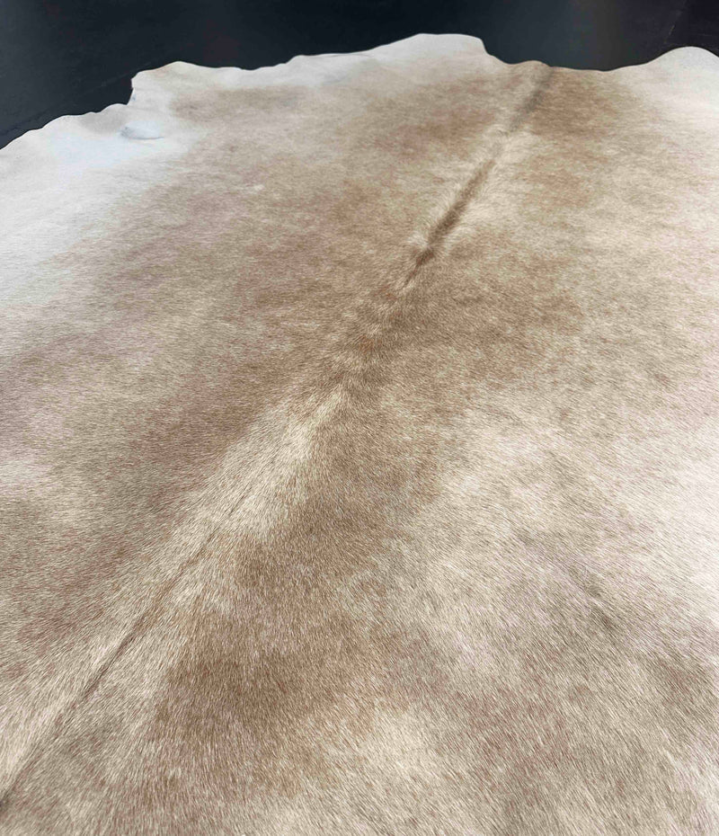 Close-up of a cowhide rug with natural patterns and colors.
