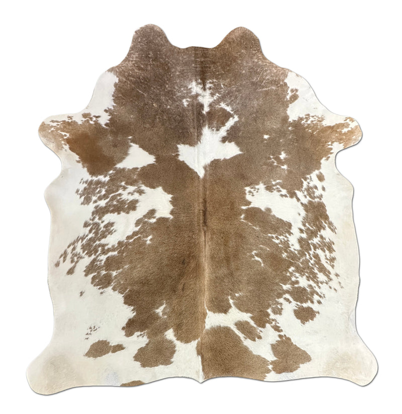 Brown and white cowhide rug on a white background