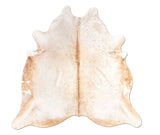 white and brown cowhide rug