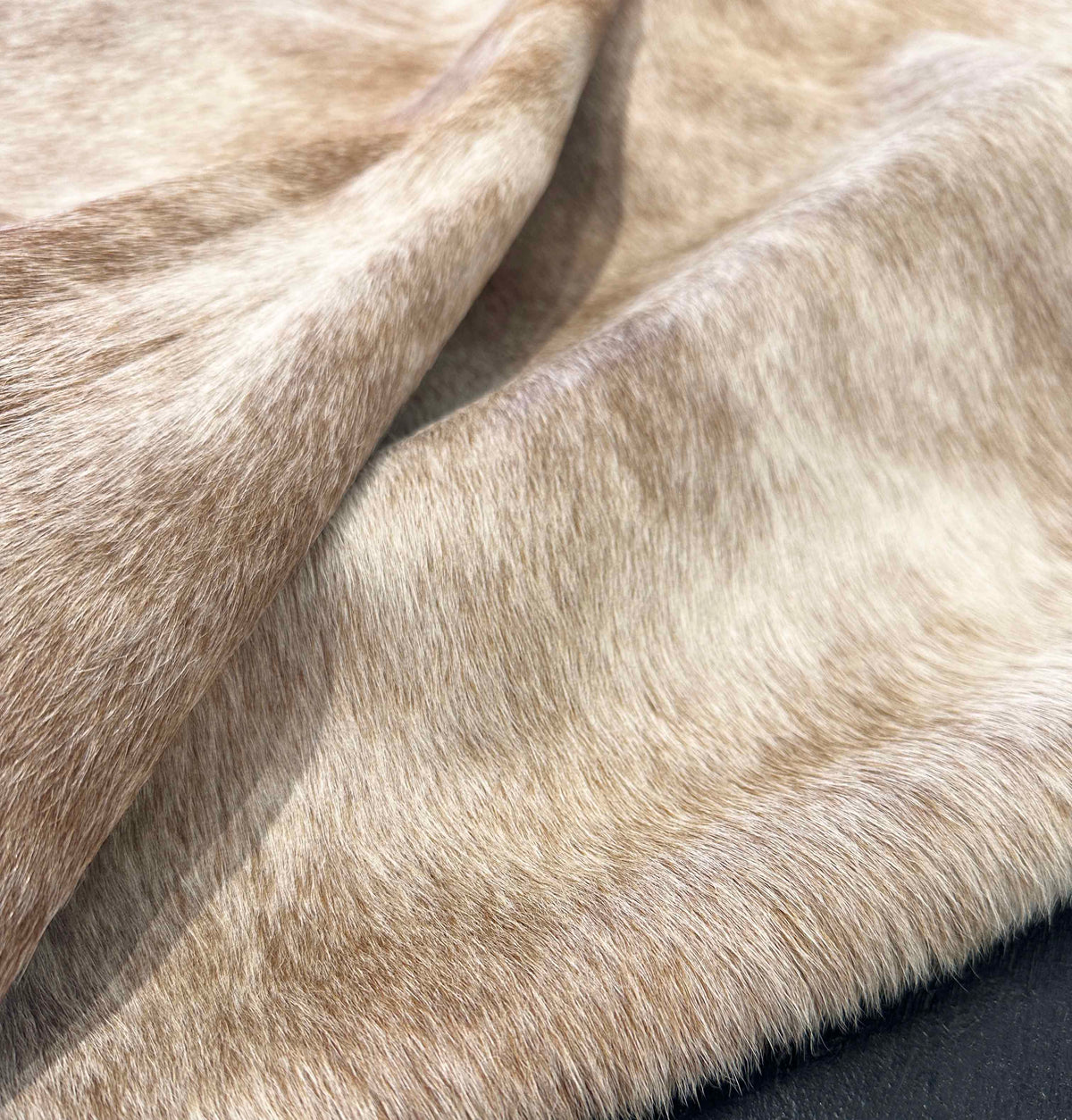 Close-up of beige cowhide rug