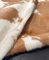Close-up of brown and white cowhide leather texture