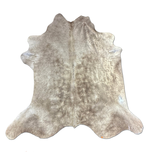 Cowhide rug with a mix of brown and gray patches on a white background