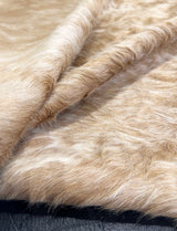 Close-up of beige fur texture cowhide rug