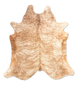 Beige cowhide rug on a white background