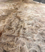 Close-up of a cowhide fur texture with a neutral color palette