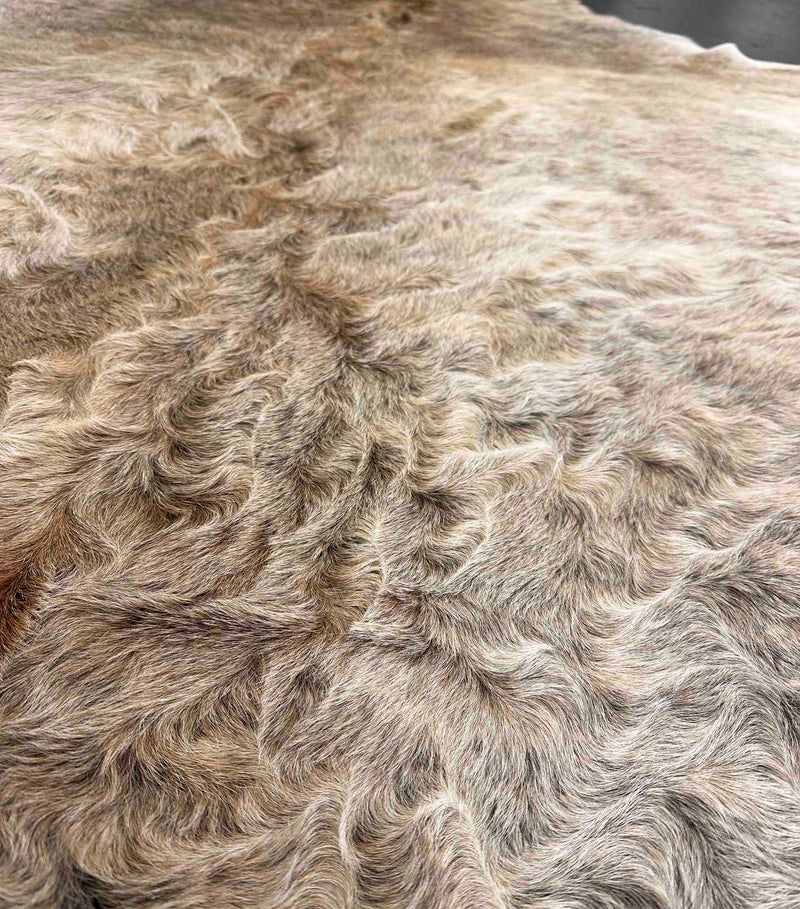 Close-up of a cowhide fur texture with a neutral color palette