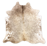 Cowhide rug with a natural pattern on a white background