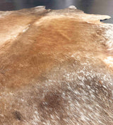 Close-up of a brown leather surface with visible texture