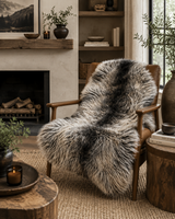 Luxury long wool sheepskin rug draped over chair in modern rustic interior